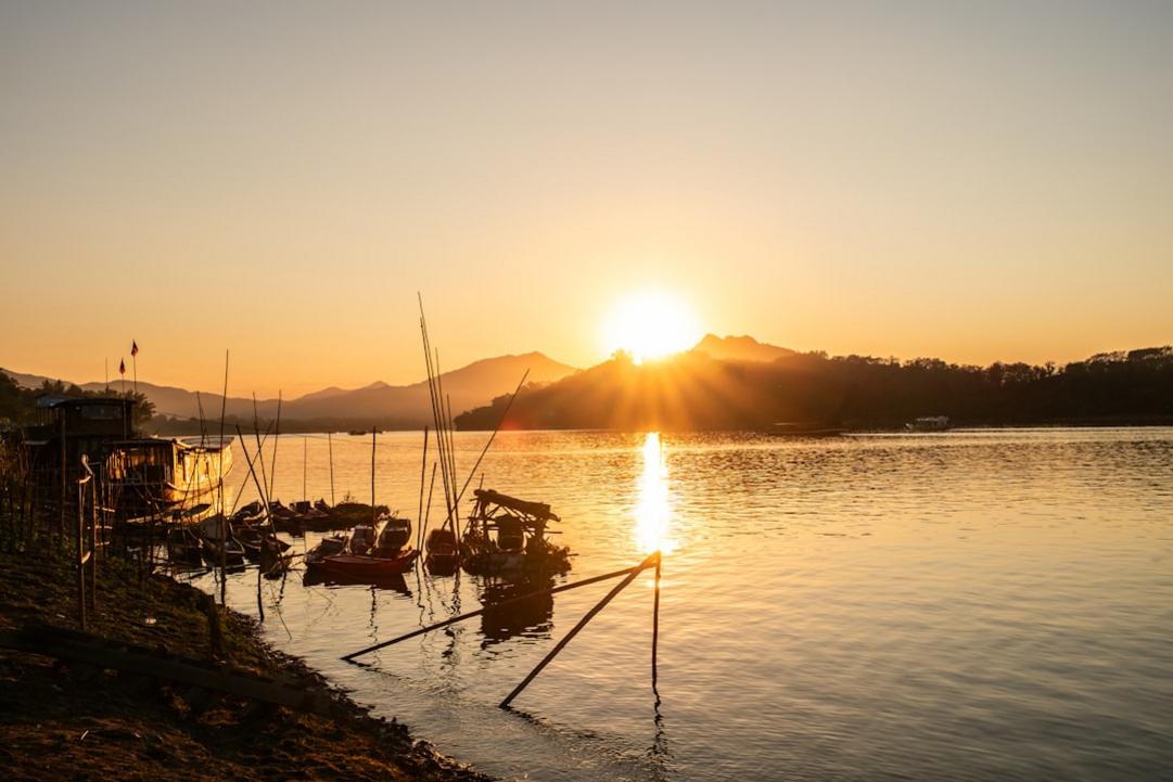 Laos Luang Prabang monks Sunset over Mekong river in Luang Prabang Laos