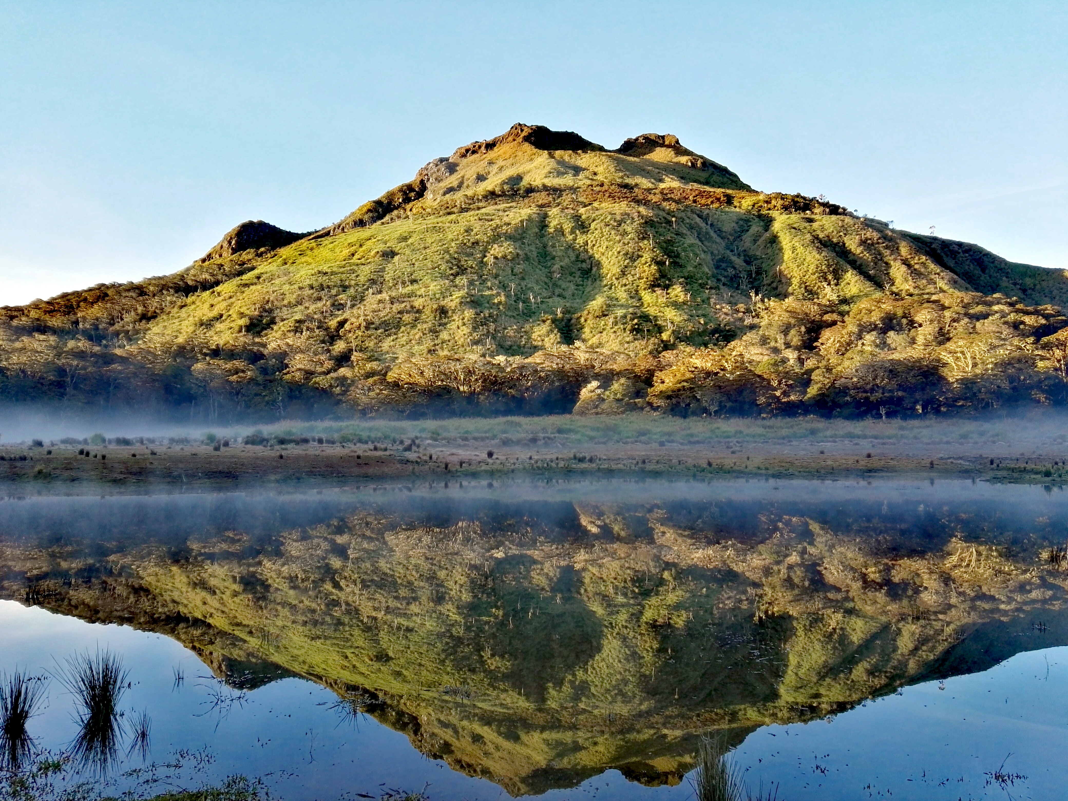 Philippines Mountains and Volcanoes: Climb 9 Distinct Peaks 4 Mount Apo volcanic peak reflected in a crater lake