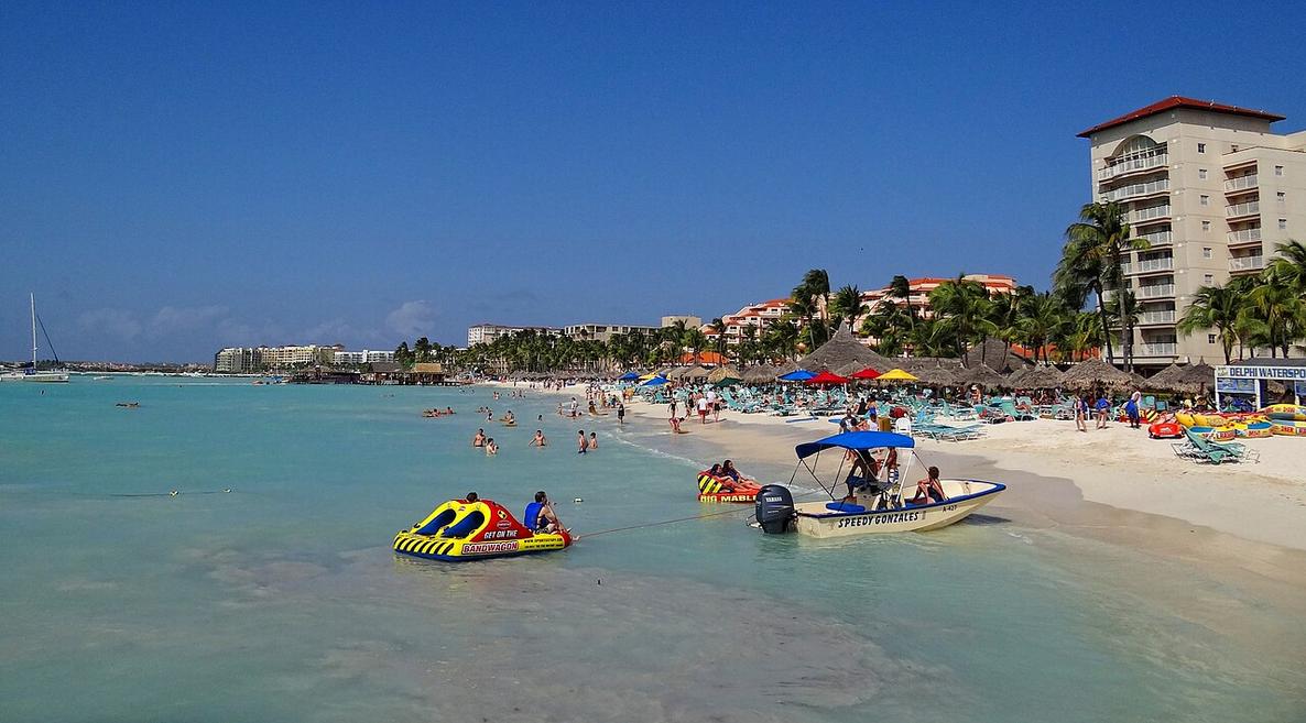 Salt air mixes with the hum of windsurf sails near Pelican Pier on Palm Beach’s sunny waterfront.
