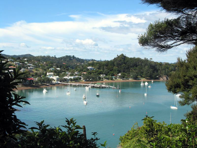 Waterfront view of Russell, New Zealand with moored yachts in the bay