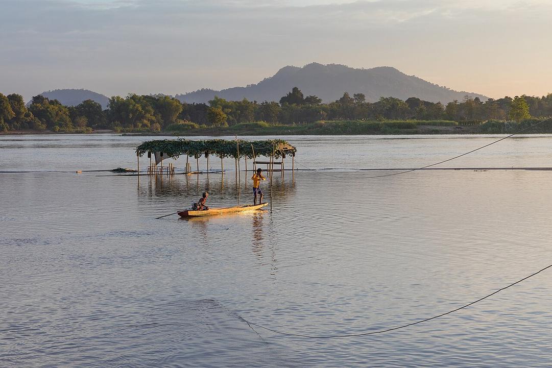 The scent of grilled fish drifts from the riverside market on Don Khon as the Mekong’s current hums nearby.