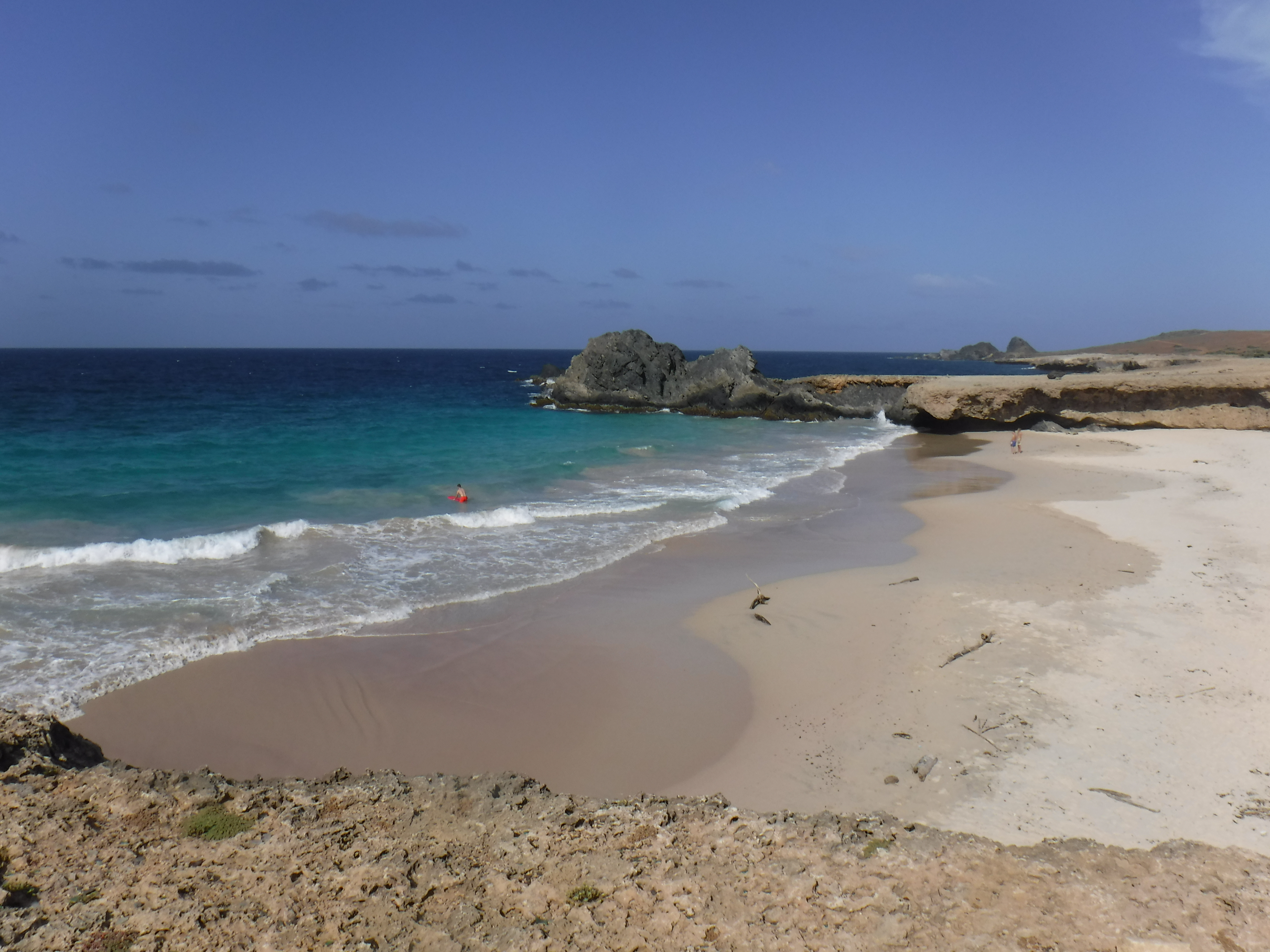 Secluded cove with turquoise water and rock formations at Andicuri Beach, northeast coast of Aruba
