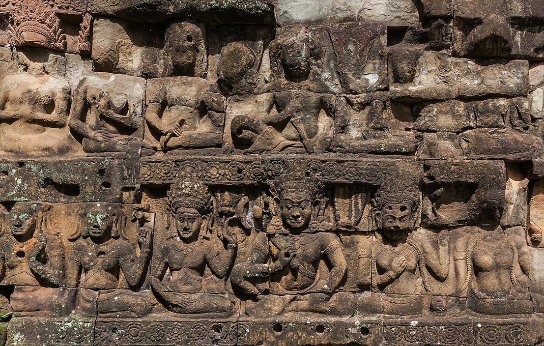 The scent of damp stone and moss rises near Ta Prohm’s crumbling walls, where roots twist through ancient carvings.