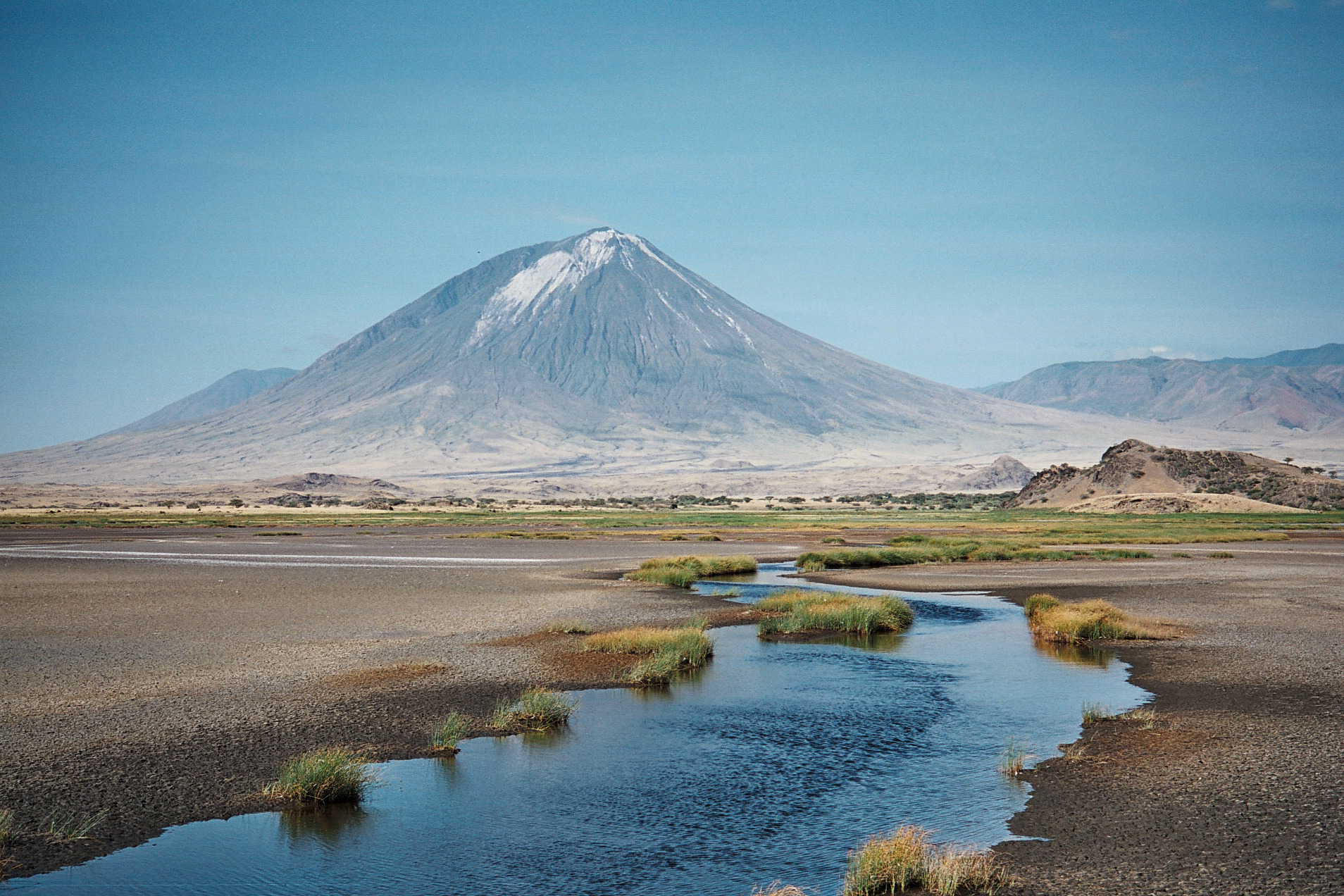 Explore Tanzania's 10 Mountains and Volcanoes 6 Ol Doinyo Lengai volcanic cone seen from Lake Natron