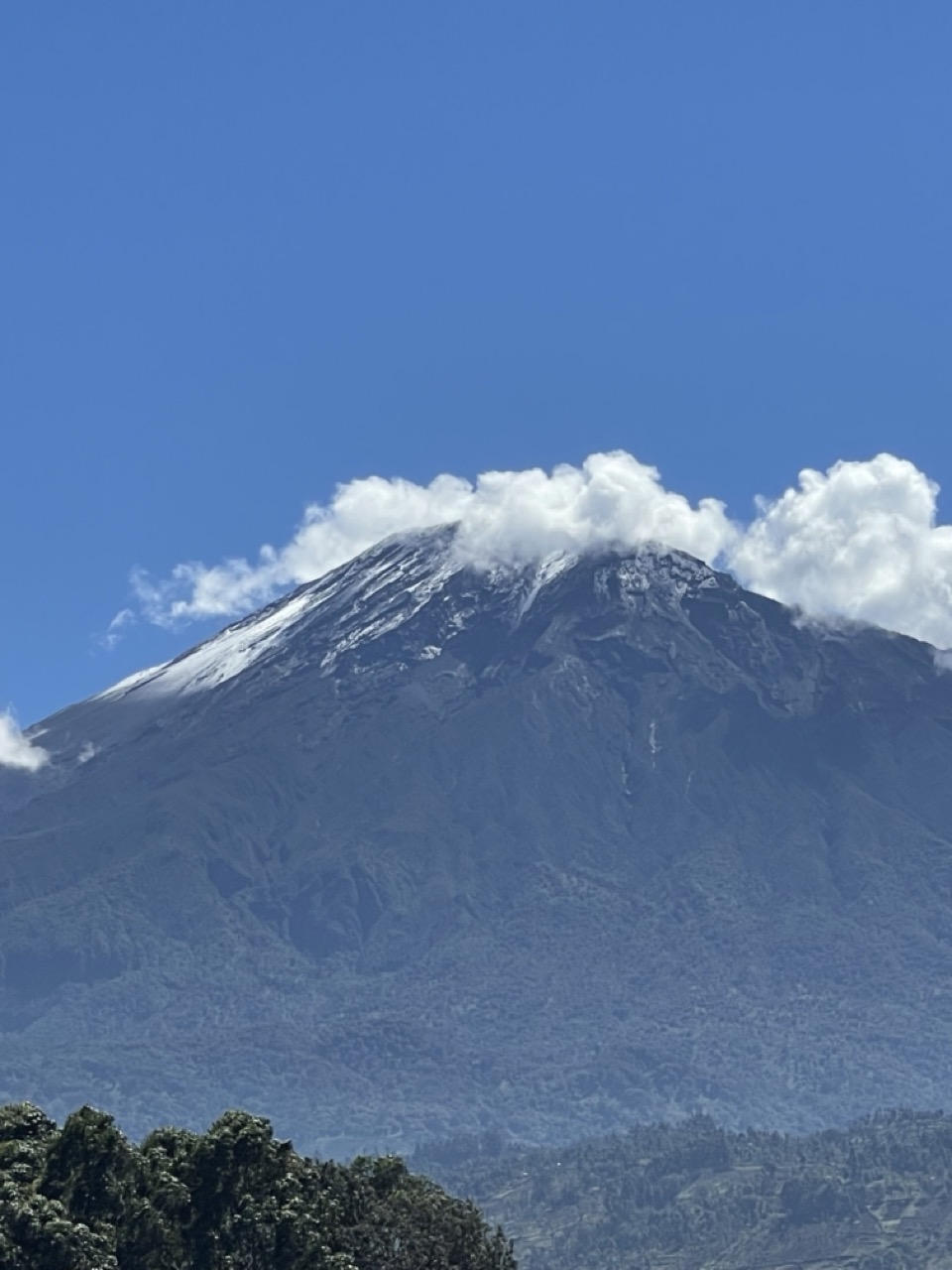 Explore Tanzania's 10 Mountains and Volcanoes 5 Mount Meru's snow-dusted crater rim, Tanzania